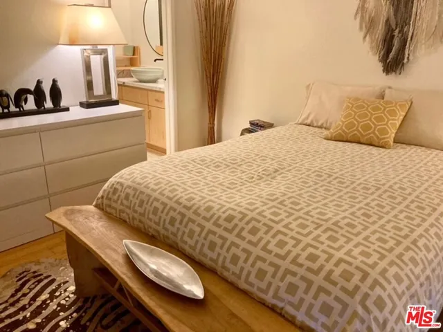 a bedroom with a bed and a lamp