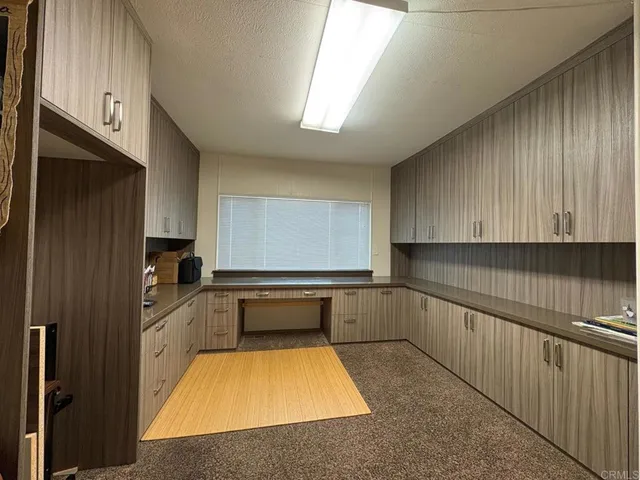 a kitchen with granite countertop a sink and cabinets