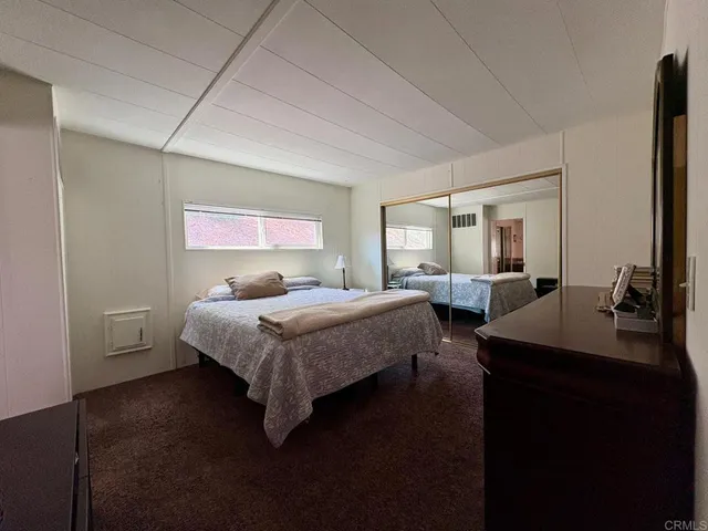 a bed room with two bed and a large window