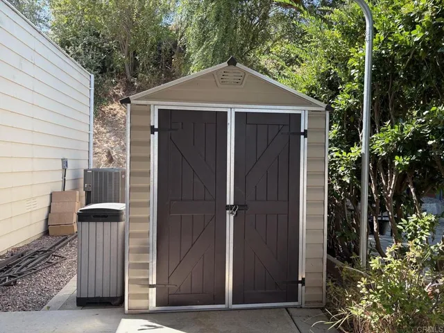 a view of wooden door and a tree