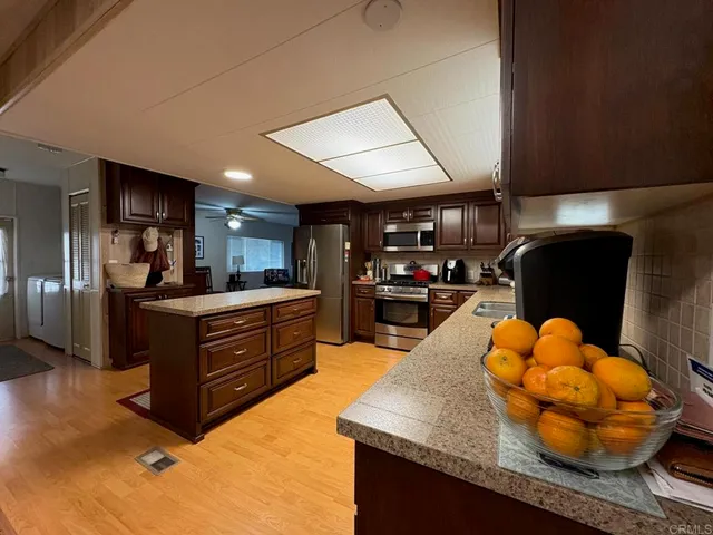 a kitchen with stainless steel appliances granite countertop a sink and a stove