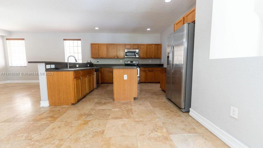 13962 Southwest 278th Street Homestead, FL 33032 - Photo 13 of 45 a kitchen with stainless steel appliances granite countertop a refrigerator and a sink