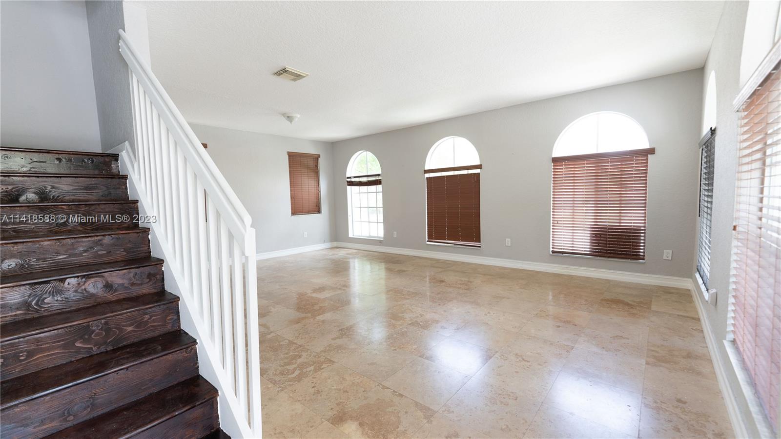 13962 Southwest 278th Street Homestead, FL 33032 - Photo 20 of 45 a view of an empty room with wooden floor and windows