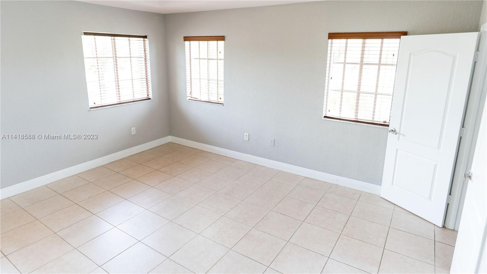 13962 Southwest 278th Street Homestead, FL 33032 - Photo 21 of 45 an empty room with windows