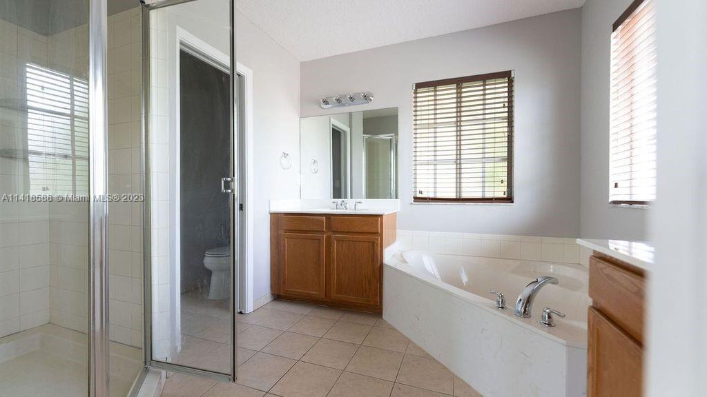 13962 Southwest 278th Street Homestead, FL 33032 - Photo 23 of 45 a bathroom with a bathtub and a sink