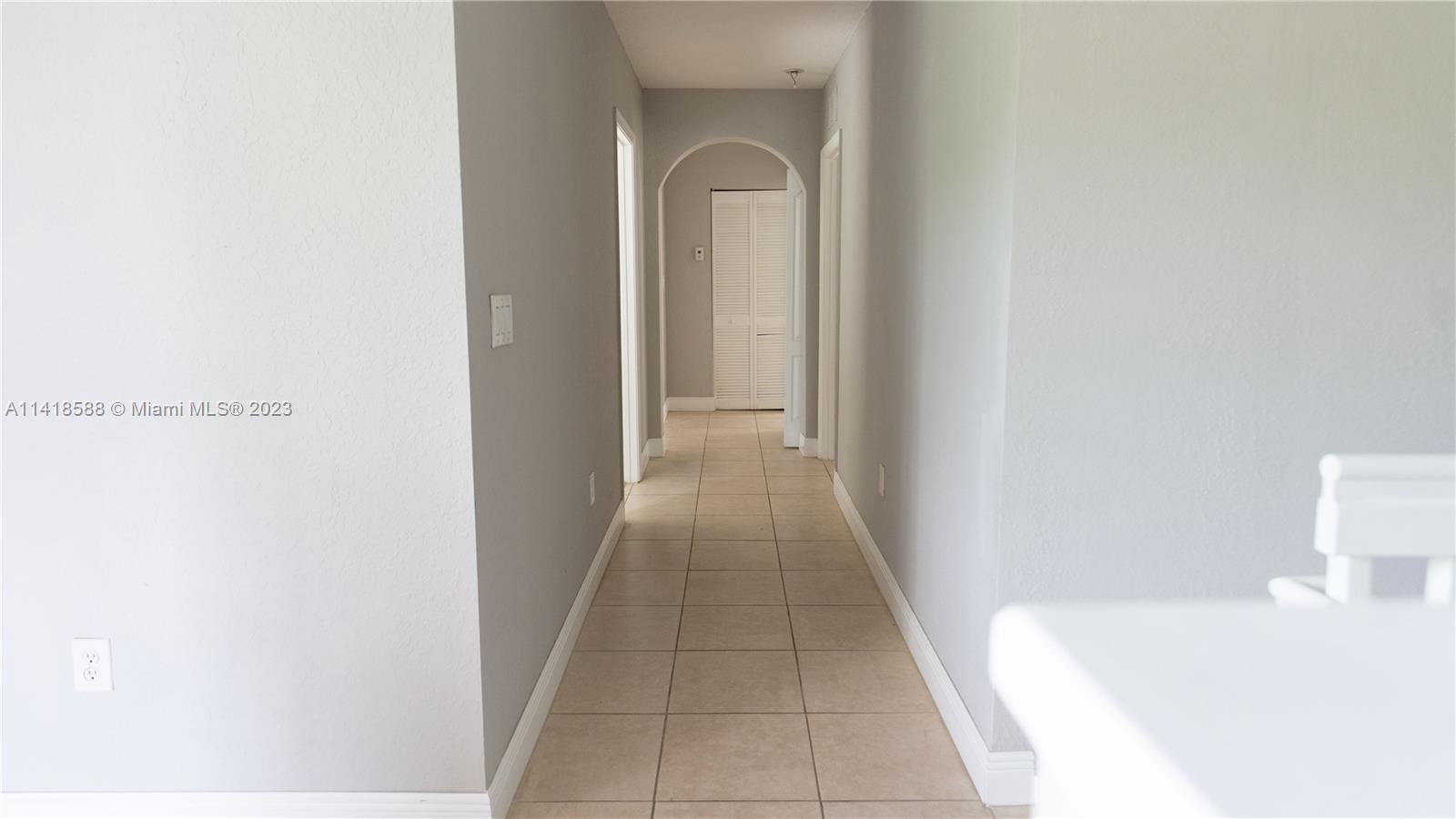 13962 Southwest 278th Street Homestead, FL 33032 - Photo 25 of 45 a hallway with sliding door and mountain view