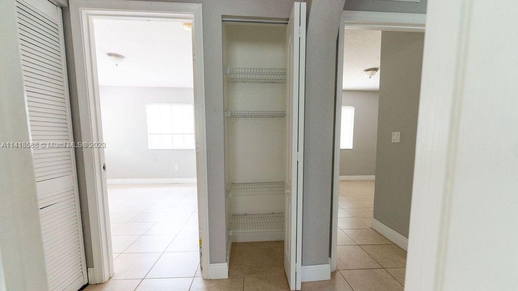 13962 Southwest 278th Street Homestead, FL 33032 - Photo 26 of 45 a bathroom with a glass shower door