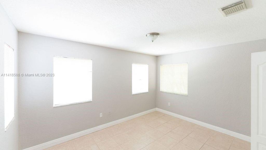 13962 Southwest 278th Street Homestead, FL 33032 - Photo 29 of 45 a view of an empty room with a window