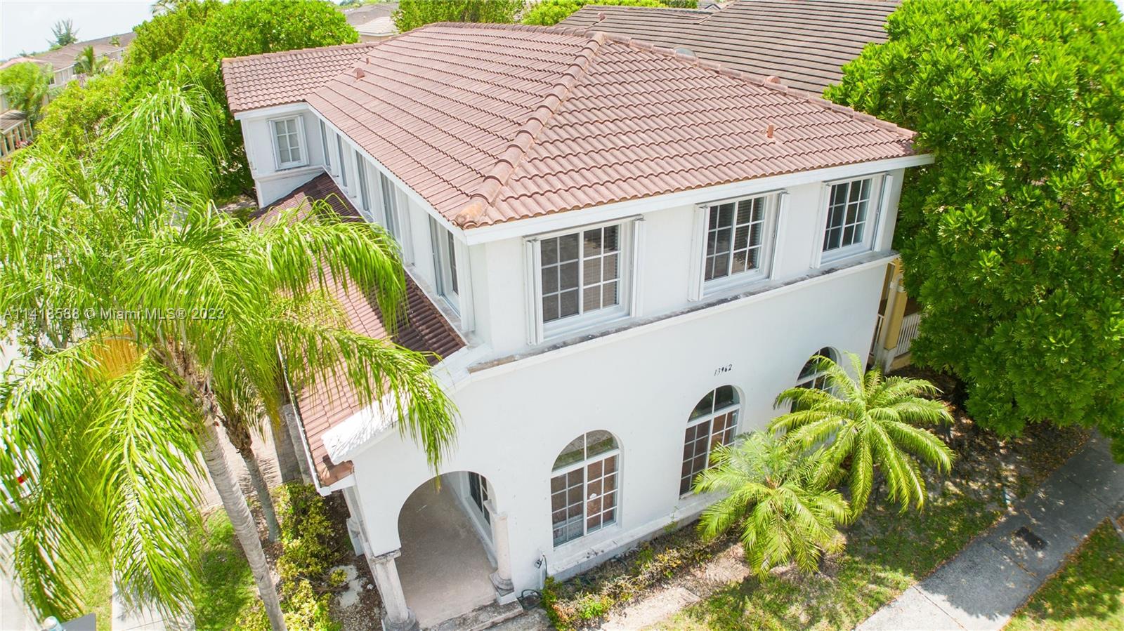 13962 Southwest 278th Street Homestead, FL 33032 - Photo 3 of 45 a front view of a house with a garden