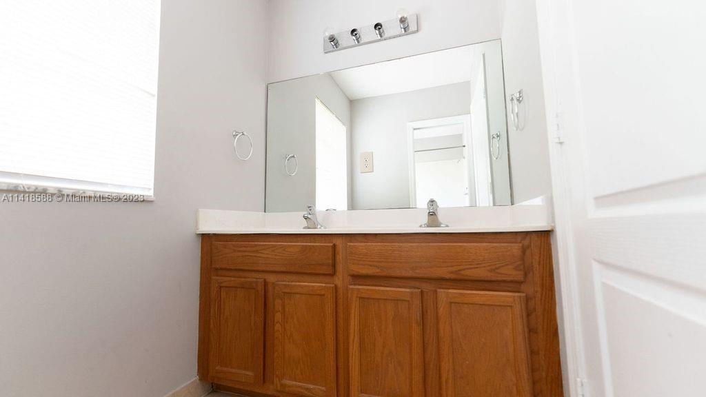 13962 Southwest 278th Street Homestead, FL 33032 - Photo 35 of 45 a bathroom with a sink and a mirror