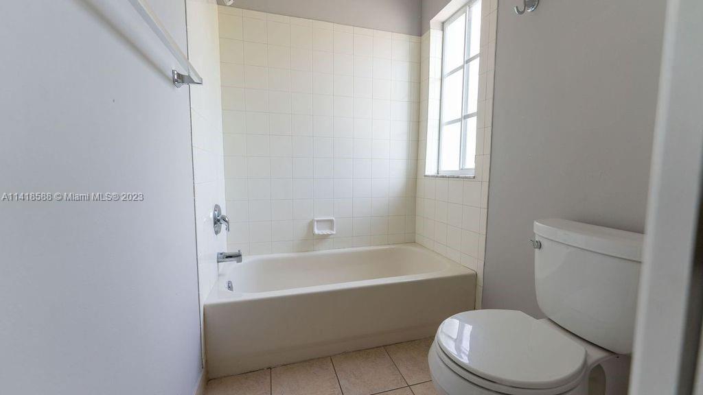 13962 Southwest 278th Street Homestead, FL 33032 - Photo 36 of 45 a bathroom with a toilet bathtub window and shower