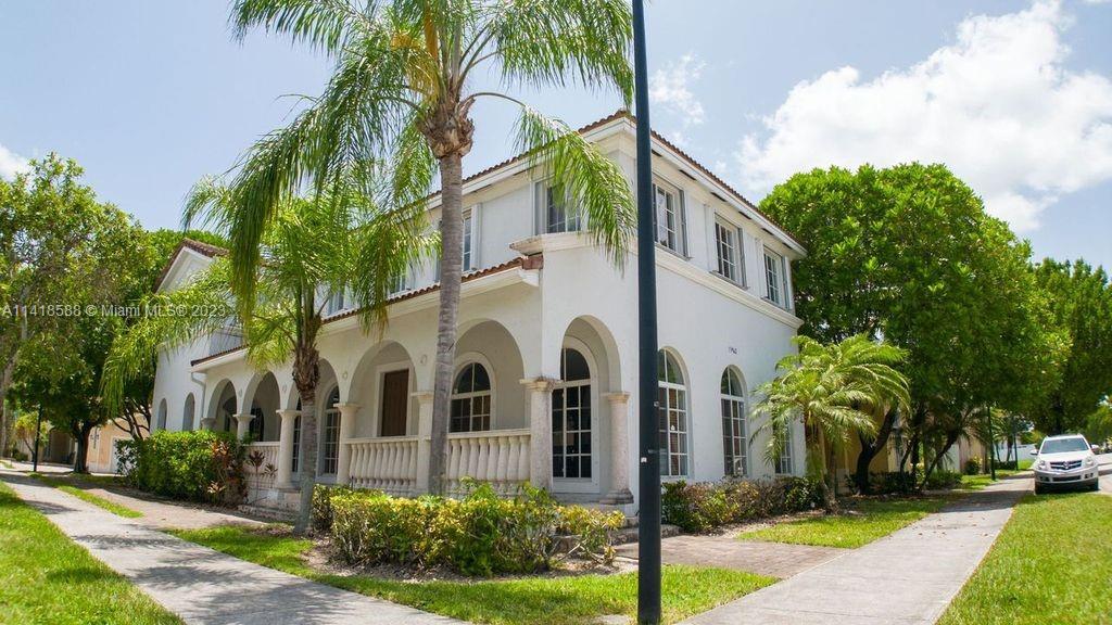 13962 Southwest 278th Street Homestead, FL 33032 - Photo 5 of 45 a view of a white house with a yard and potted plants