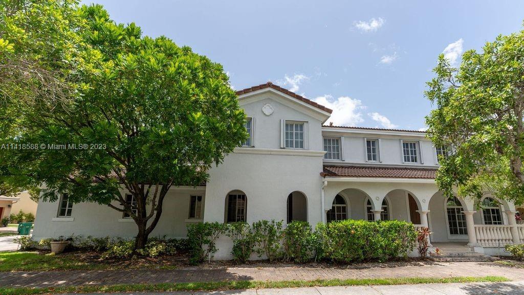 13962 Southwest 278th Street Homestead, FL 33032 - Photo 8 of 45 a front view of a house with a garden