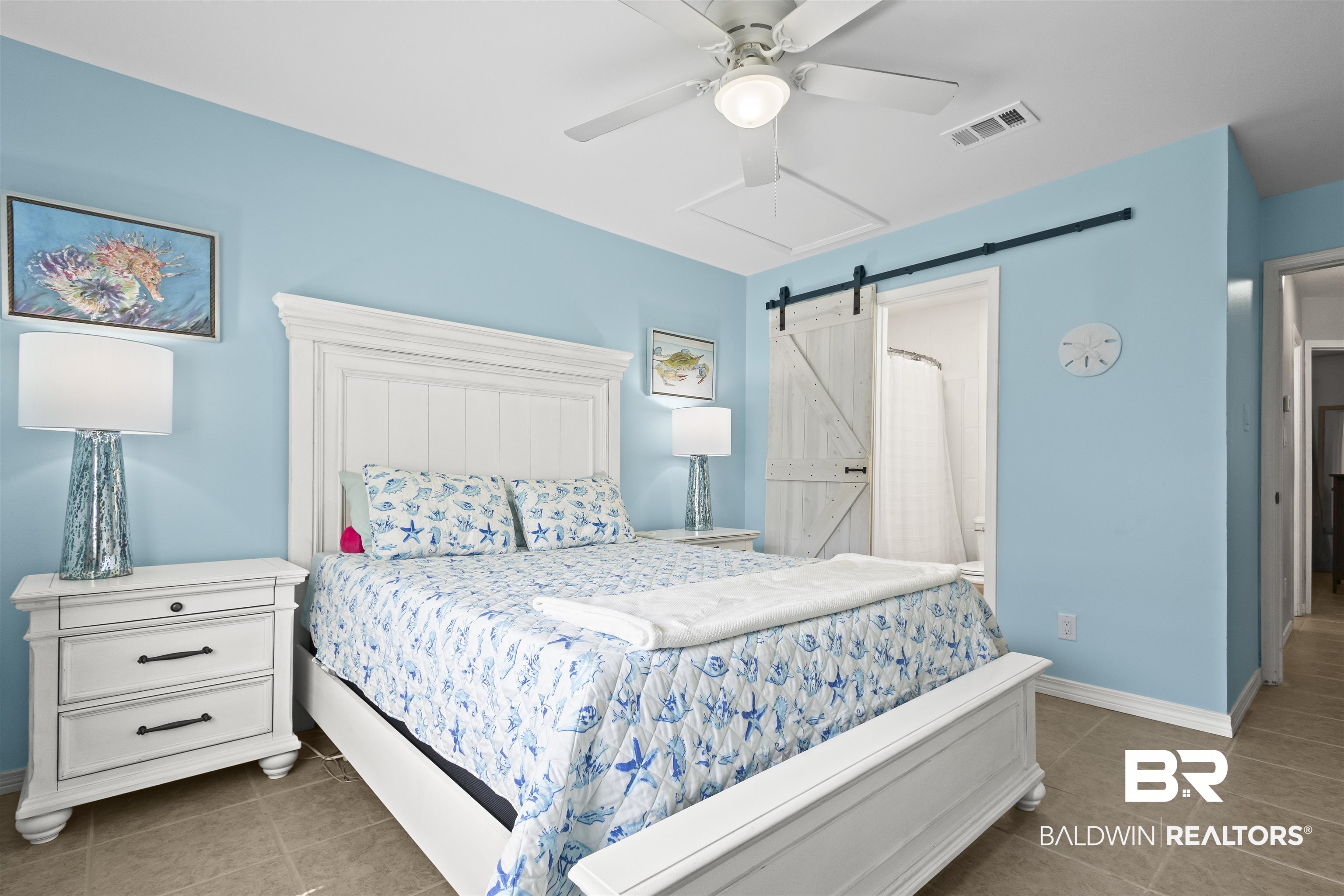 25925 Canal Road, Unit 207 Orange Beach, AL 36561 - Photo 25 of 42 Bedroom featuring a barn door, ceiling fan, and dark tile flooring