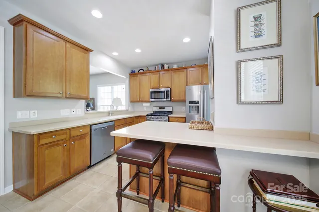 a kitchen with a refrigerator cabinets and wooden floor