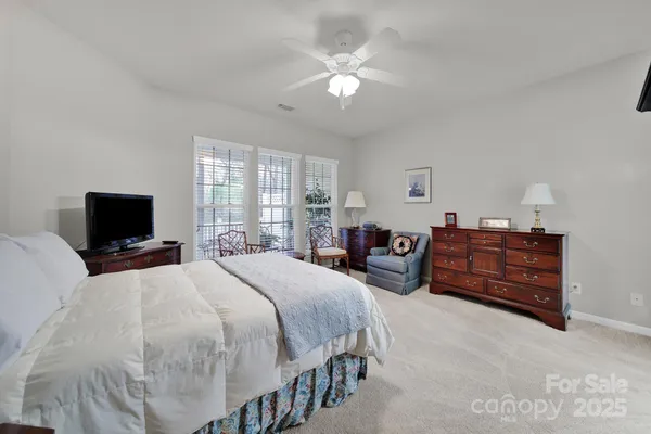 a bedroom with a bed and a television