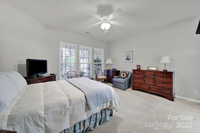 a bedroom with a bed and a television