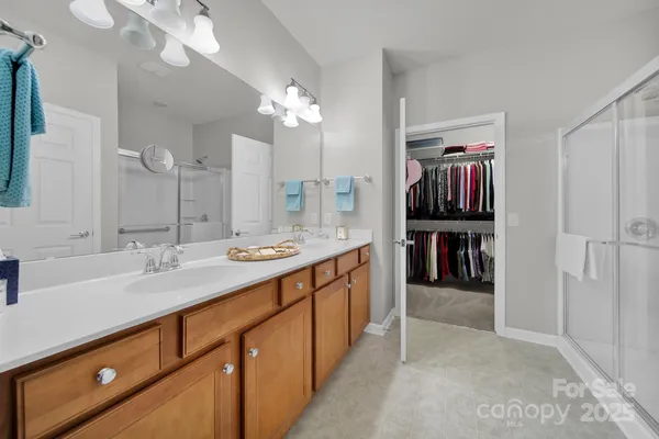 a spacious bathroom with a double vanity sink and a mirror