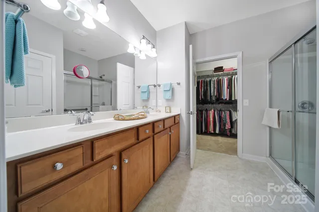 a spacious bathroom with a double vanity sink and a mirror