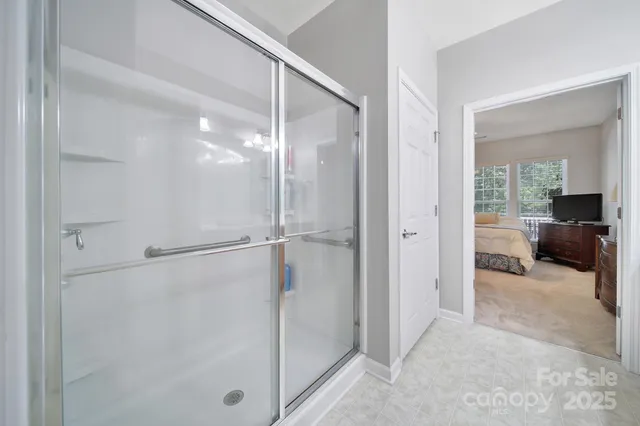 a view of a livingroom with a walk in closet and bathroom