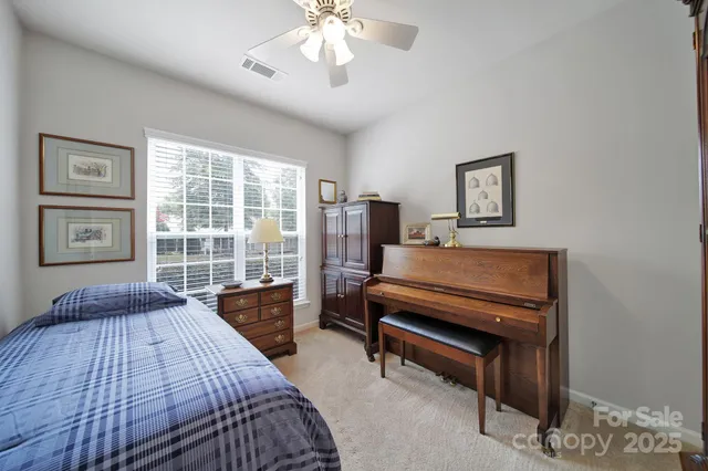 a bedroom with furniture and a window