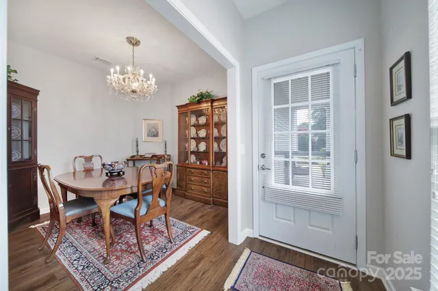 a view of a dining room with furniture and chandelier