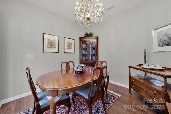 a dining room with furniture and chandelier