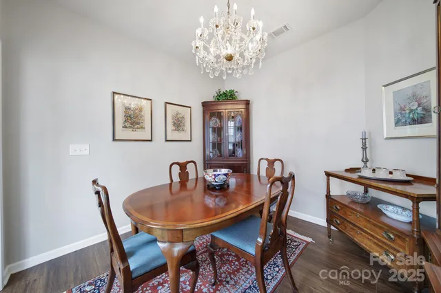 a dining room with furniture and chandelier