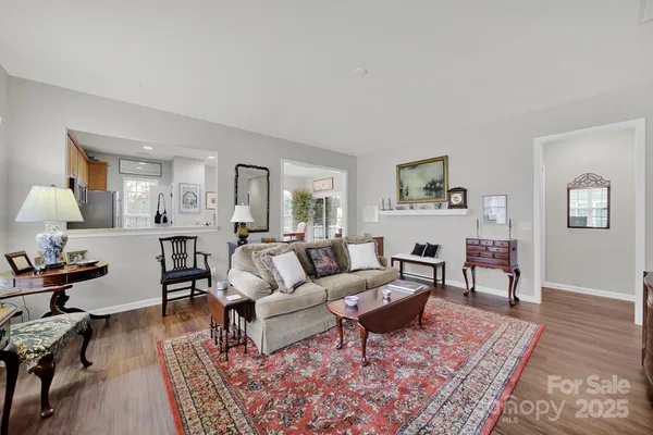 a living room with furniture a rug and a lamp