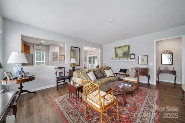 a living room with furniture rug and wooden floor