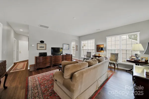 a living room with furniture flat screen tv and window