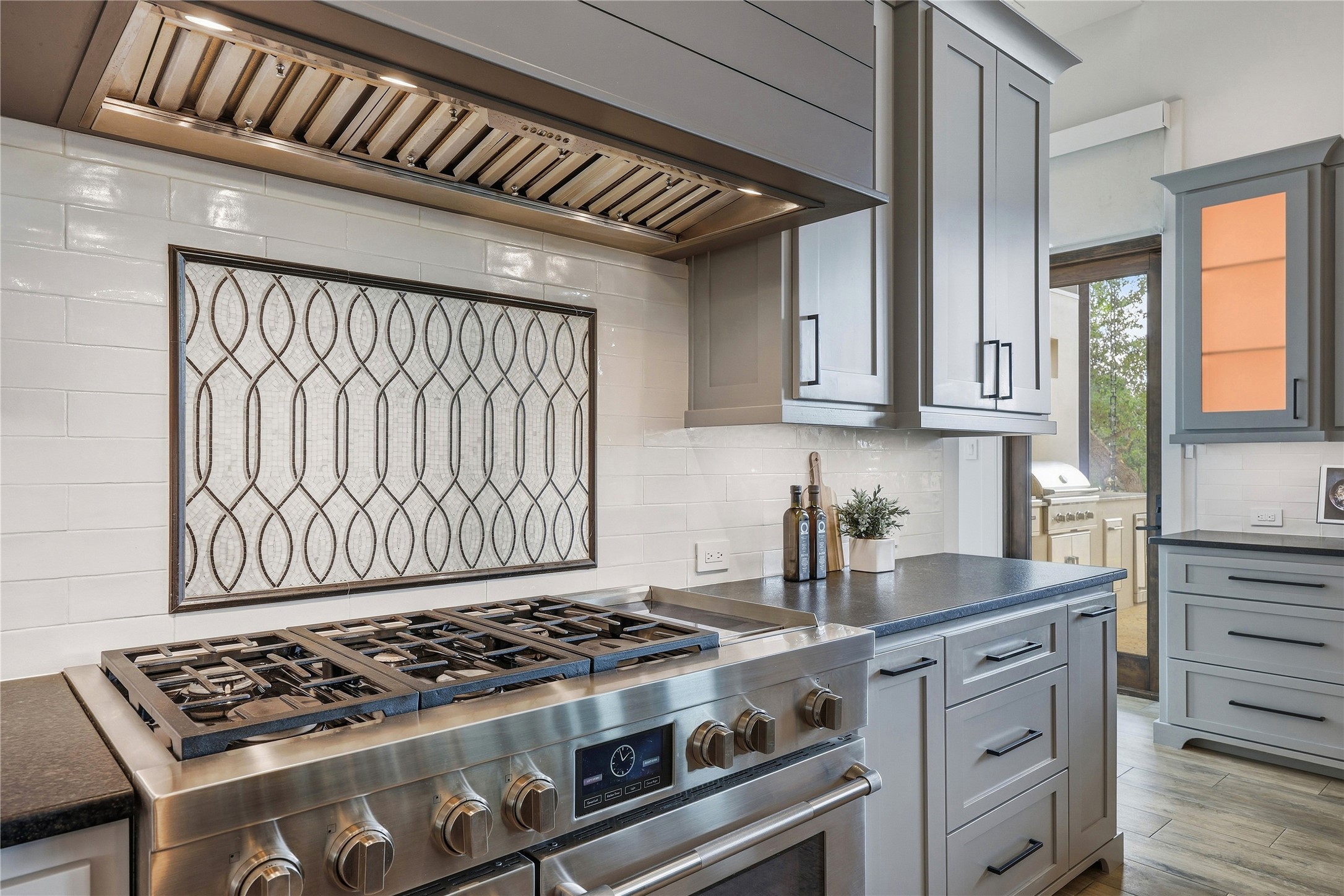 449 Ranch Falls Fair Oaks Ranch, TX 78015 - Photo 13 of 39 Gleaming stone countertops and custom cabinetry elevate this modern culinary space.