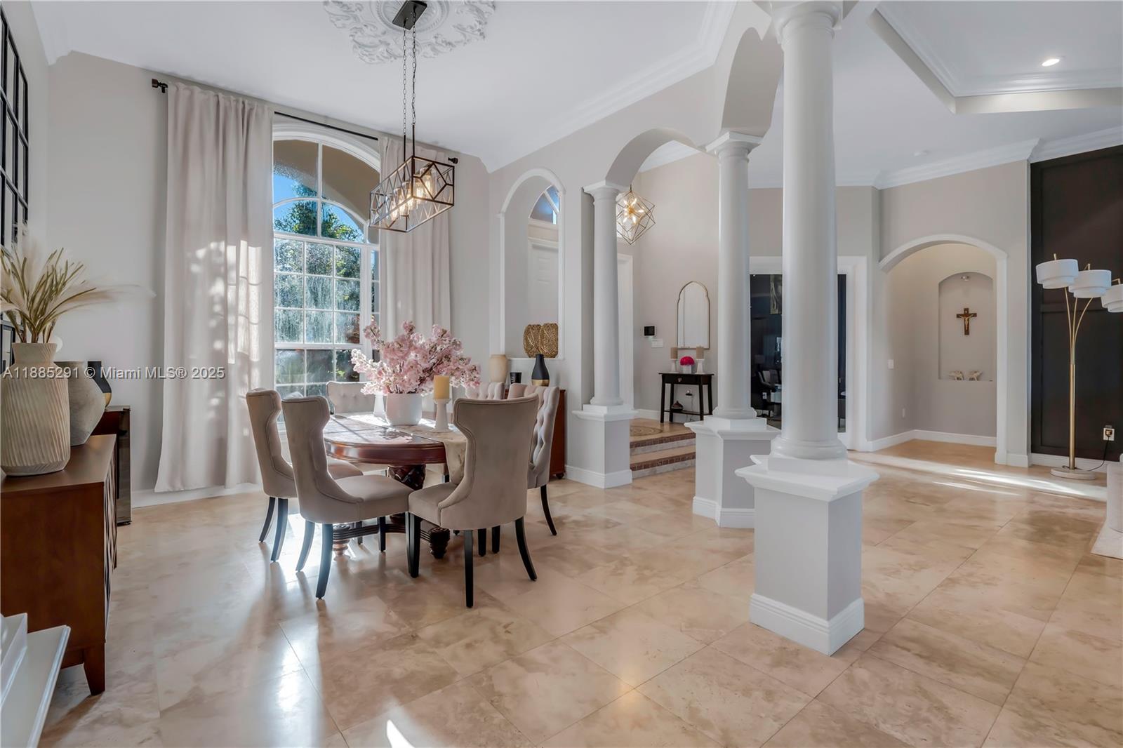 4166 Southwest 190th Avenue Miramar, FL 33029 - Photo 12 of 70 a dining room with furniture a chandelier and wooden floor