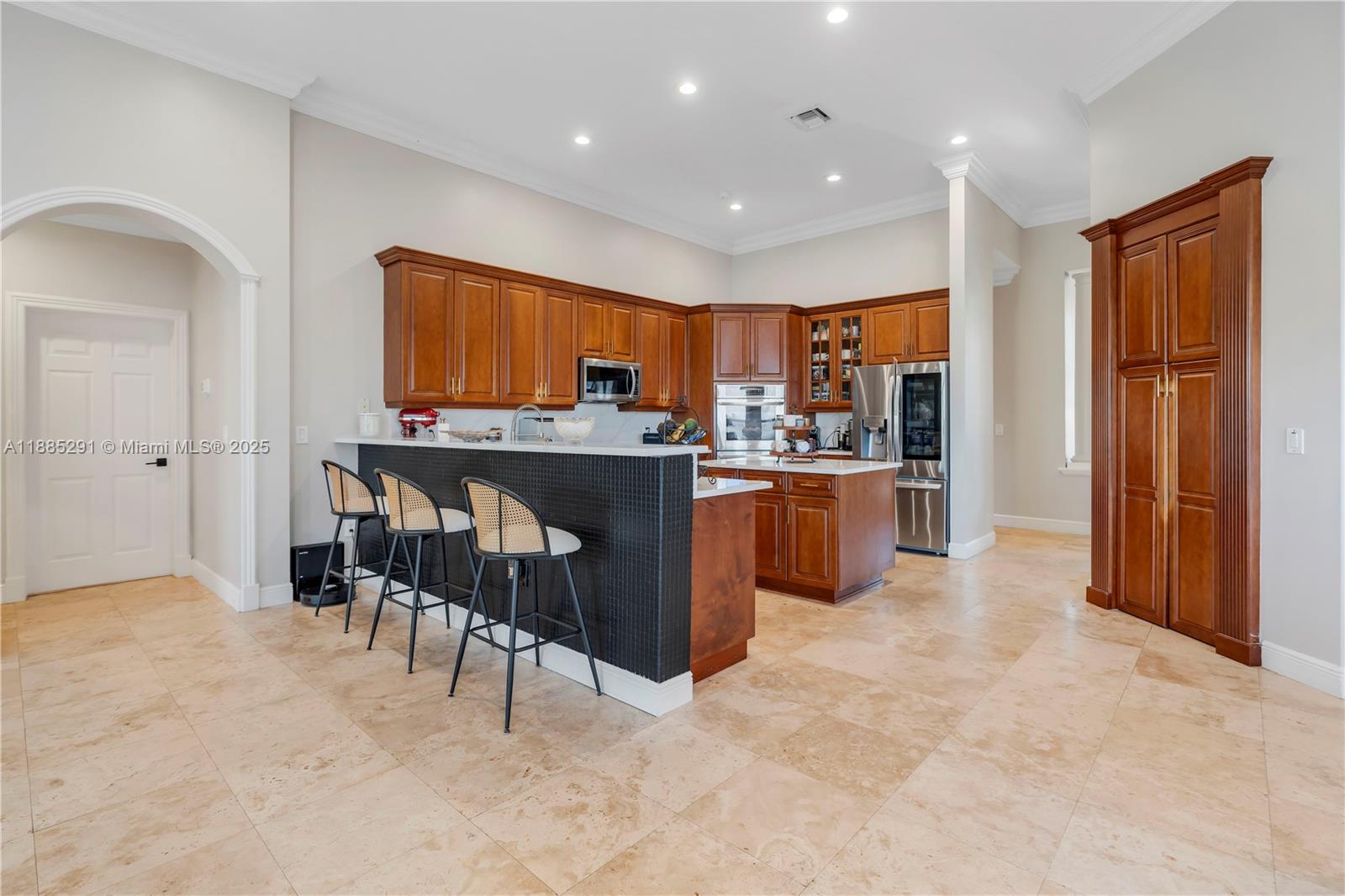 4166 Southwest 190th Avenue Miramar, FL 33029 - Photo 27 of 70 a kitchen with stainless steel appliances granite countertop a stove top oven a sink and a refrigerator