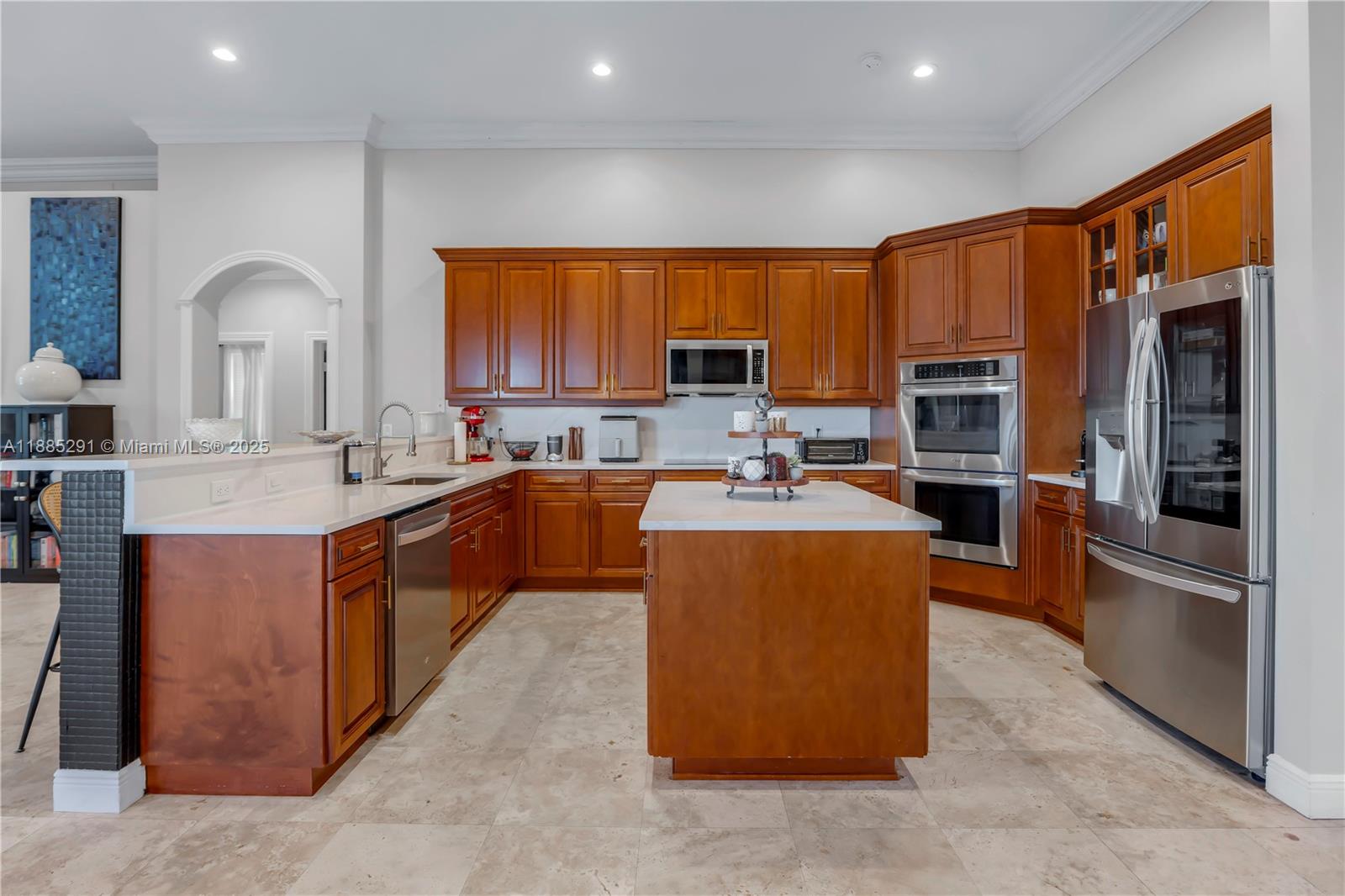 4166 Southwest 190th Avenue Miramar, FL 33029 - Photo 9 of 70 a kitchen with stainless steel appliances granite countertop a stove top oven a sink and a refrigerator