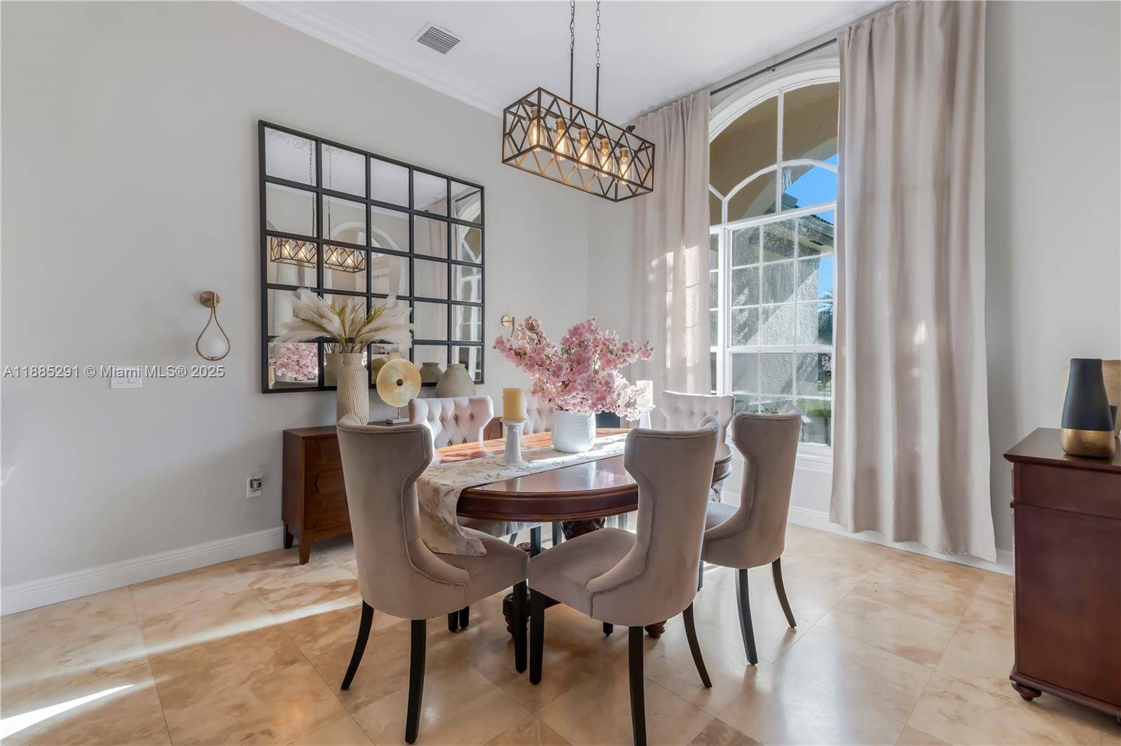 4166 Southwest 190th Avenue Miramar, FL 33029 - Photo 10 of 70 a dining room with furniture a chandelier and wooden floor