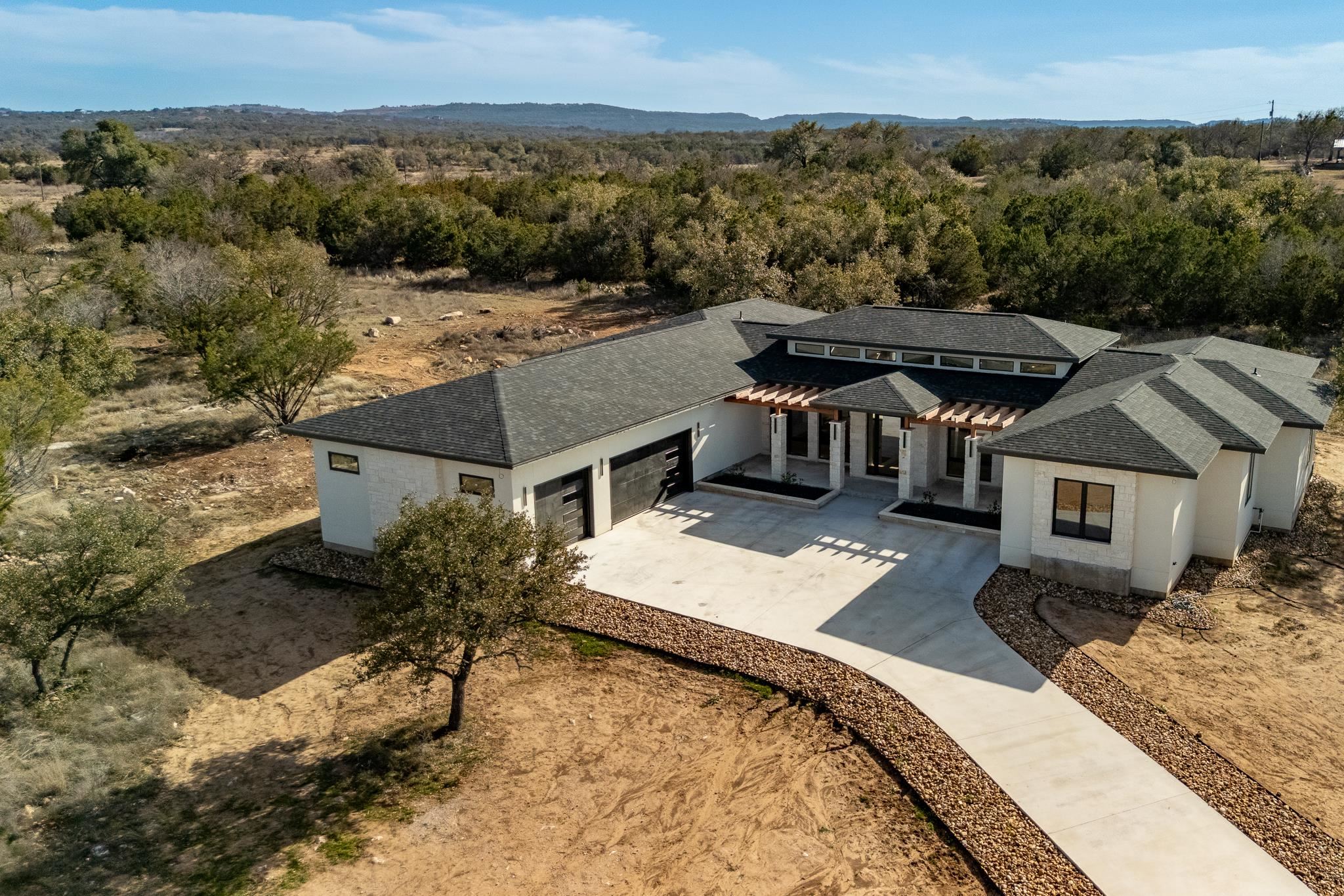 an aerial view of a house with a yard