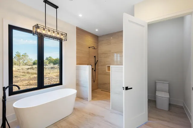 a spacious bathroom with a bathtub and a shower