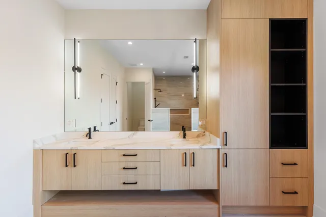 a bathroom with a double vanity sink and mirror
