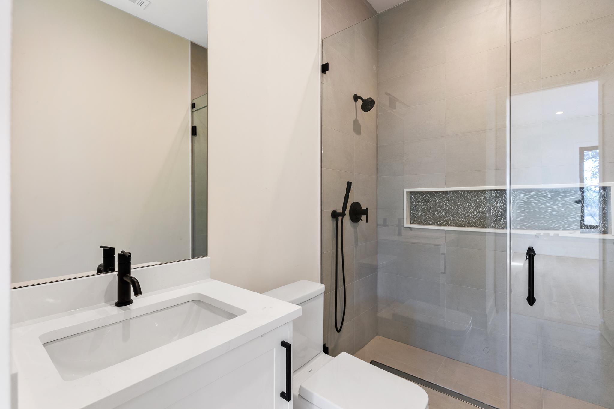 6425 Ranch Road 962 West Round Mountain, TX 78663 - Photo 21 of 30 a bathroom with a sink a toilet and shower