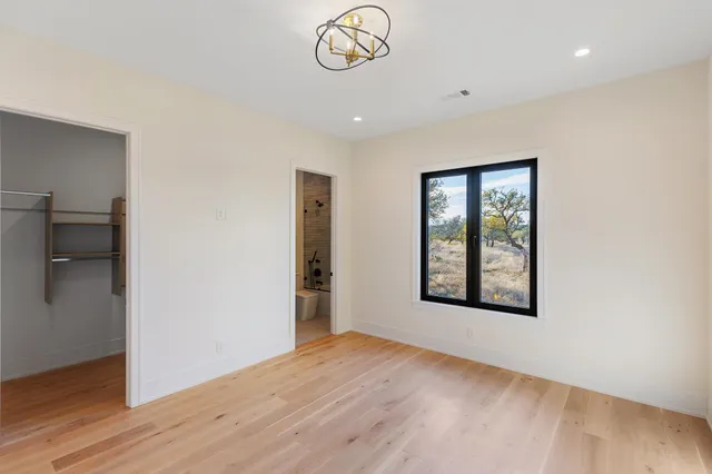 an empty room with wooden floor and a window