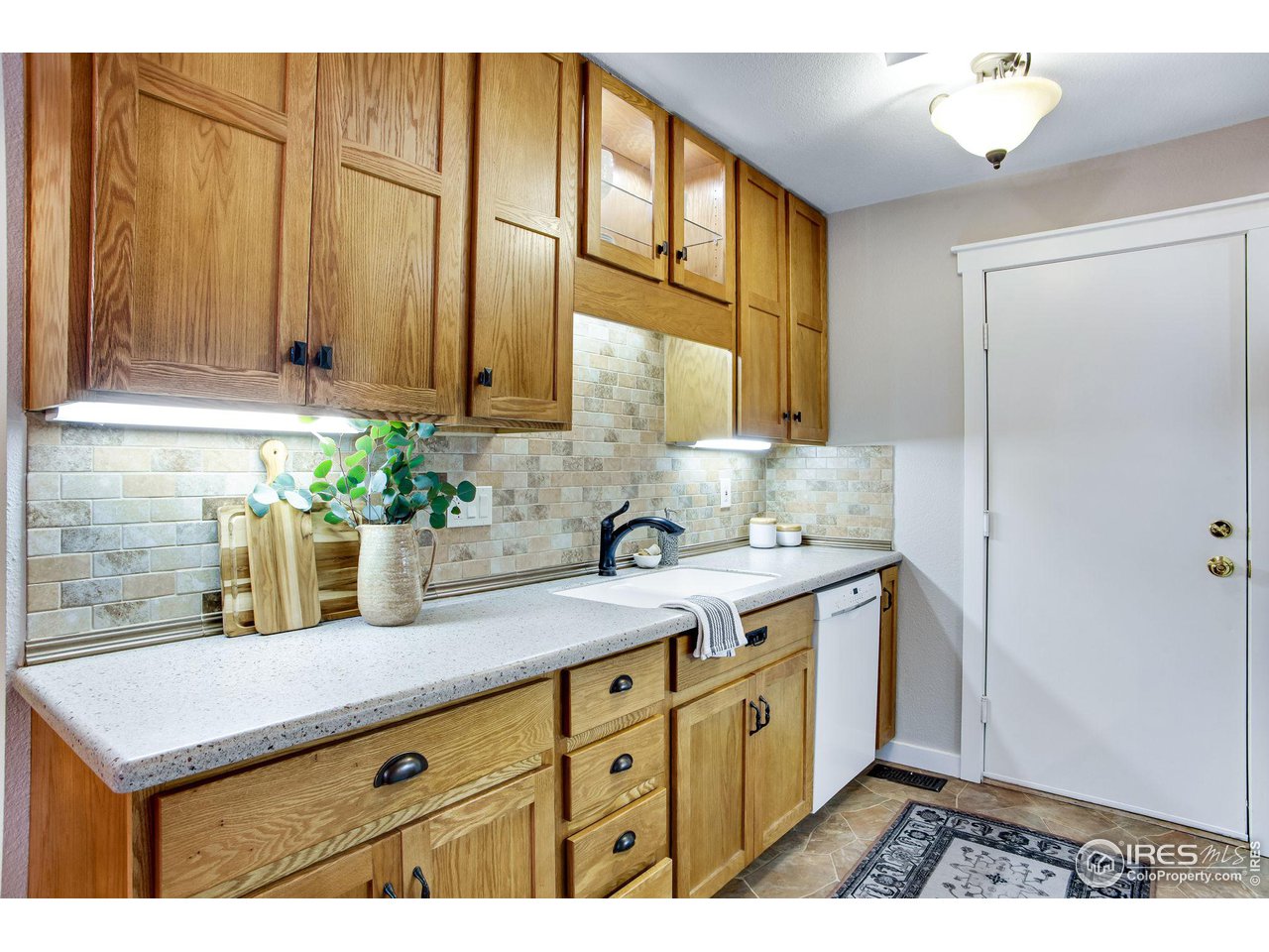 60 Lodgepole Drive Windsor, CO 80550 - Photo 14 of 27 a kitchen with stainless steel appliances granite countertop a sink a stove and a refrigerator