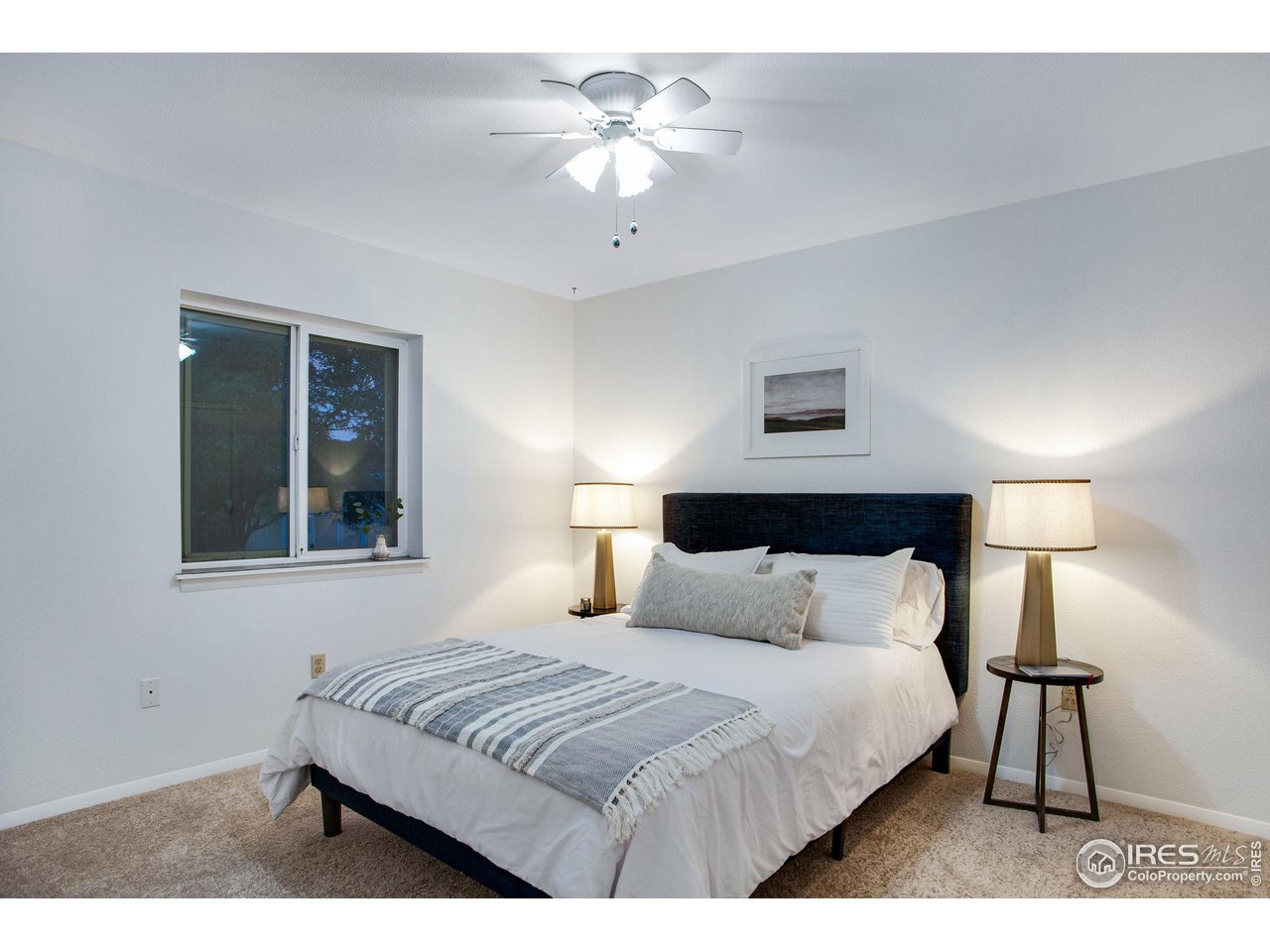 60 Lodgepole Drive Windsor, CO 80550 - Photo 16 of 27 a bedroom with a bed and a lamp