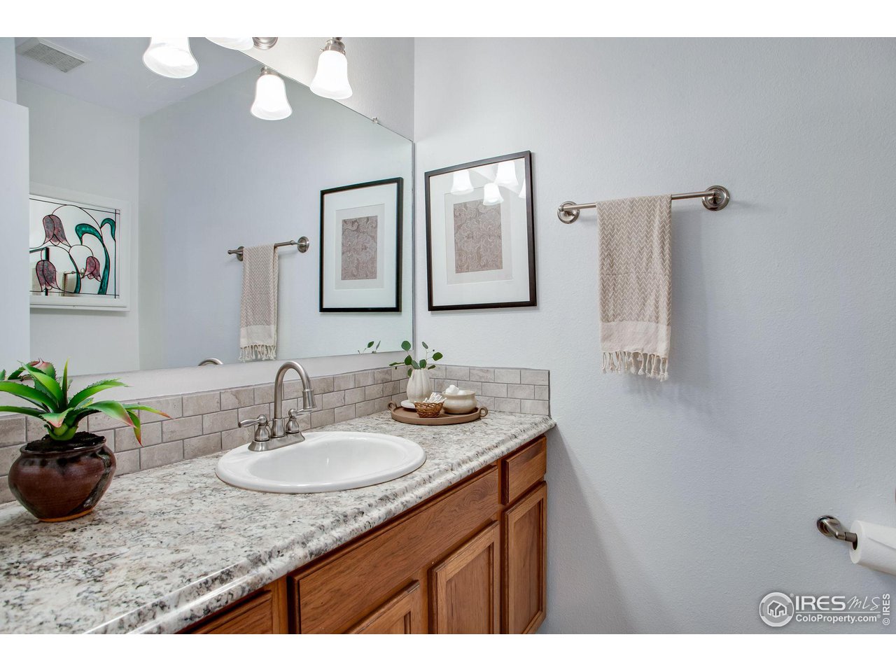 60 Lodgepole Drive Windsor, CO 80550 - Photo 17 of 27 a bathroom with a granite countertop sink a mirror and a