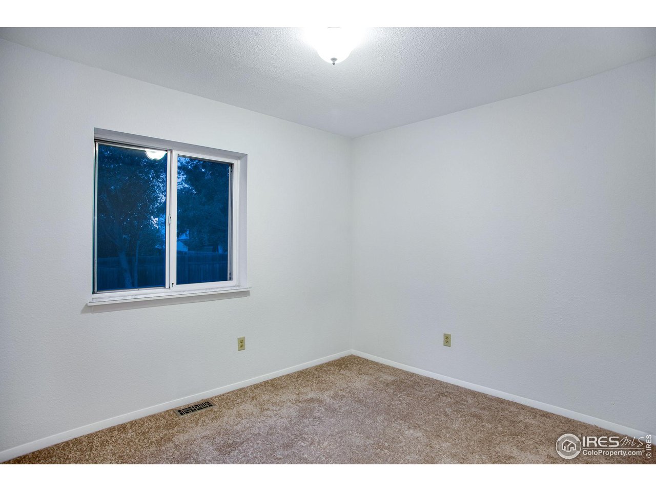 60 Lodgepole Drive Windsor, CO 80550 - Photo 20 of 27 a view of an empty room with a window