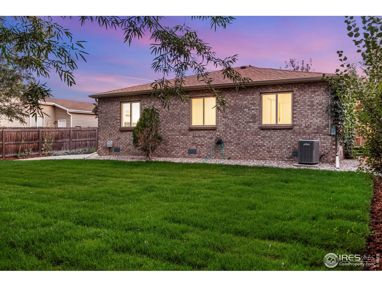 60 Lodgepole Drive Windsor, CO 80550 - Photo 25 of 27 a front view of a house with a big yard and a fountain