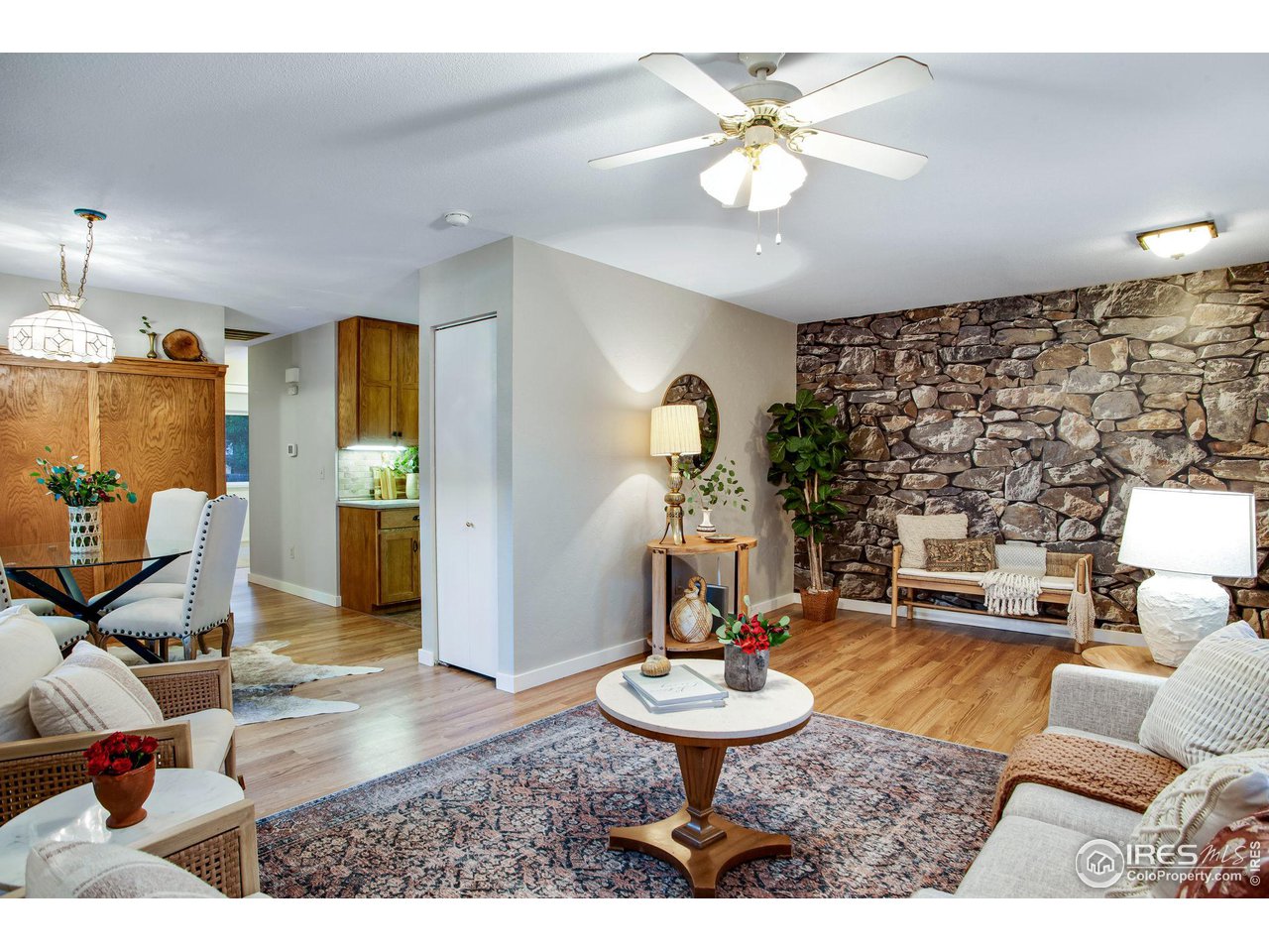 60 Lodgepole Drive Windsor, CO 80550 - Photo 8 of 27 a living room with furniture and a chandelier
