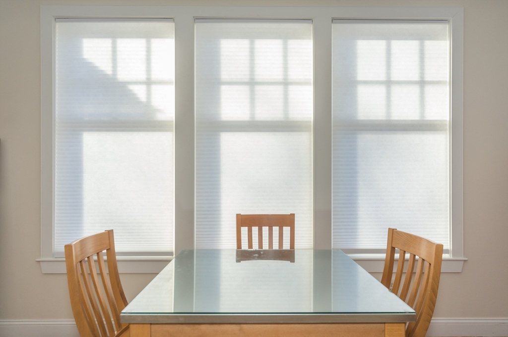 53 Winslow Road, Unit A Brookline, MA 02446 - Photo 13 of 16 a view of a dining room with furniture and wooden floor