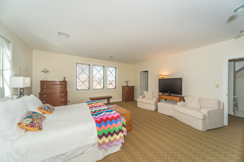 53 Winslow Road, Unit A Brookline, MA 02446 - Photo 15 of 16 a bedroom with furniture and a flat screen tv