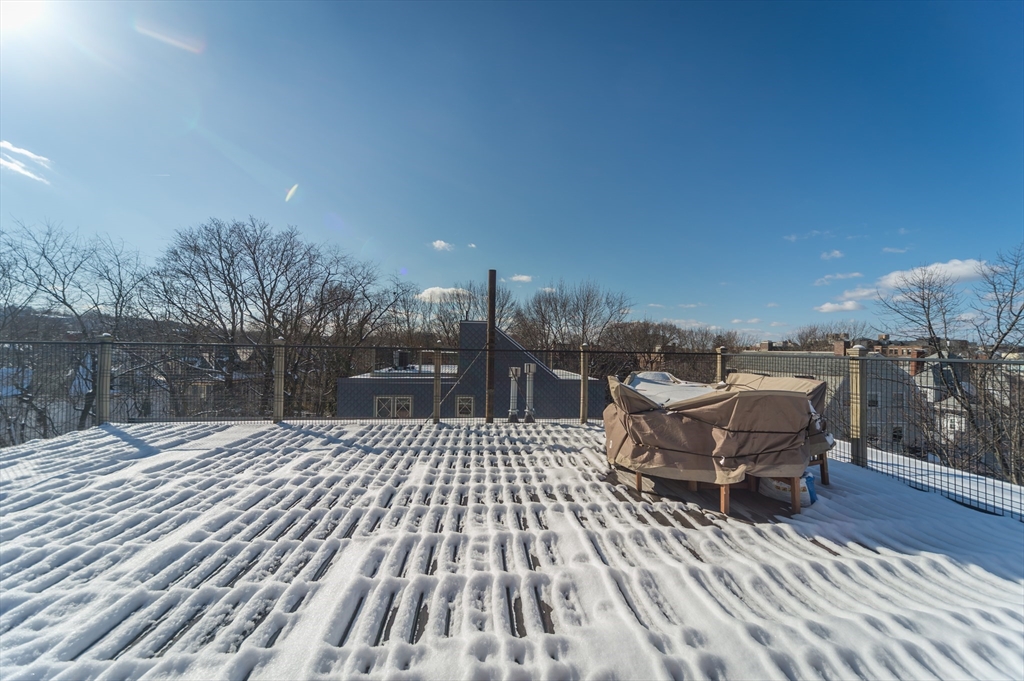 53 Winslow Road, Unit A Brookline, MA 02446 - Photo 16 of 16 a terrace with outdoor seating and trees